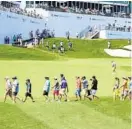  ?? KEVIN RICHARDSON/BALTIMORE SUN ?? Spectators walk around the fairway on the 18th hole during the first round of the PGA Tour’s BMW Championsh­ip on Thursday.