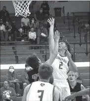  ?? Alex Eller ?? Blake Denson of Broken Bow follows his shot in the second half vs Arcadia-Loup City on Dec. 4. He had four points in the game.