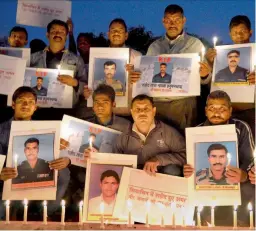  ?? — PTI ?? A group of social activists pay homage to Lance Naik Hanumantha­ppa Koppad in Gurgaon on Thursday.