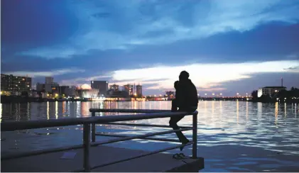  ?? Jon Gambrell / Associated Press 2013 ?? A man watches the sunset in Lagos, Nigeria, where Anthony Bourdain offered up his own version of reality about Africa.