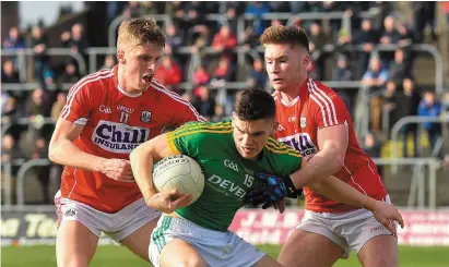  ??  ?? Donal Lenihan of Meath has little room to manoeuvre as he is tackled by Cork’s Sean White and Kevin Flahive