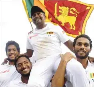  ?? (AFP) ?? Sri Lanka’s Rangana Herath (second from right) is carried off the field by teammates after the first Test against England yesterday.