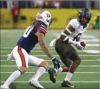  ?? RON JENKINS — THE ASSOCIATED PRESS ?? Oregon safety Jevon Holland (8) intercepts a pass in front of Auburn wide receiver Sal Cannella (80) during the first half of a 2019 game in Arlington, Texas.