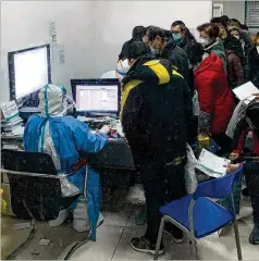  ?? CHRIS BUCKLEY/THE NEW YORK TIMES ?? Patients wait Tuesday for medical attention at a Wuhan hospital, near the epicenter of the virus outbreak in China.