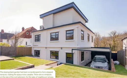  ??  ?? The sloping back garden has been re-landscaped to form stepped terraces, making the space more useable. There are no windows on the rear of the roof extension, for the sake of neighbours’ privacy