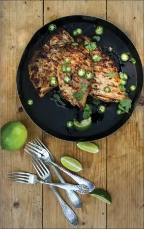  ??  ?? Grilled Sesame Lime Chicken Breasts are garnished with green chilies and cilantro.