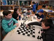  ?? ?? Members of the Reeds Brook Middle School chess team practice at the Hampden Academy library in Hampden.