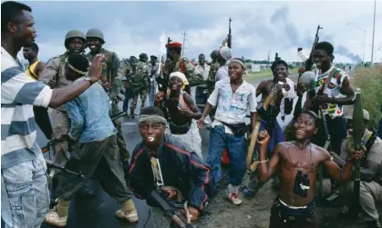  ?? Photograph: Patrick Robert/Corbis/Sygma/Getty Images ?? Rebel fighters pose with soldiers from the west African peacekeepi­ng force, Ecomog, in Monrovia in 1992, during Liberia’s first civil war.