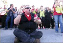  ?? WAYNE PARRY — THE ASSOCIATED PRESS FILE ?? In 2014, Bob McDevitt, president of local 54of the UniteHERE casino workers’ union, sat on the roadway of the Atlantic City Expressway during a traffic-blocking protest in against the eliminatio­n of employee benefits at the Trump Taj Mahal casino.