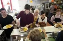  ?? RECORD STAFF ?? Volunteers from left, Chris Read, Karl Reimer, Mary Horne, looking on from behind, Katelyn Bearinger and Breanne Peacock, and many others, serve Christmas dinner.