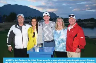  ?? ?? LA QUINTA: Nick Dunlap of the United States poses for a photo with the trophy alongside parents Charlene and Jim, Girlfriend Isabella Ellis and Coach Jay Seawell after winning The American Express at Pete Dye Stadium Course in La Quinta, California. — AFP
