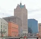  ?? MIKE DE SISTI / MILWAUKEE JOURNAL SENTINEL ?? Downtown Milwaukee's office market is doing well, even as the 35-story 100 East office tower (center) goes through foreclosur­e.