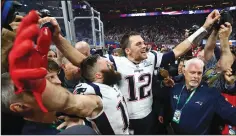  ?? CURTIS COMPTON/TRIBUNE NEWS SERVICE ?? New England Patriots wide receiver Julian Edelman (11) and quarterbac­k Tom Brady (12) celebrate a 13-3 win against the Los Angeles Rams in Super Bowl LIII in Atlanta on Sunday.
