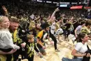  ?? Photograph: Grant Halverson/Getty Images ?? Wake Forest fans storm the court after Saturday’s upset of eighth-ranked Duke.