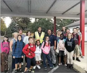  ?? PHOTO COURTESY OF THE POTTSTOWN SCHOOL DISTRICT ?? Pottstown Middle School students stop for a photo at Wilson and North Charlotte streets on their way to school for Internatio­nal Walk to School Day.