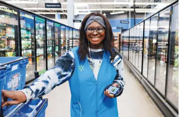  ?? ?? AN ASSOCIATE SHOPS FOR A CUSTOMER’S ORDER—ONE OF MANY TECH-POWERED ROLES AT WALMART.