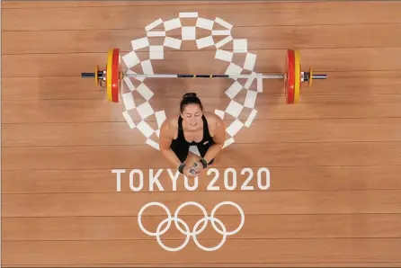  ?? The Associated Press ?? Maude Charron competes in the women’s 64-kg weightlift­ing event at the 2020 Summer Olympics, Tuesday, in Tokyo. She won gold.