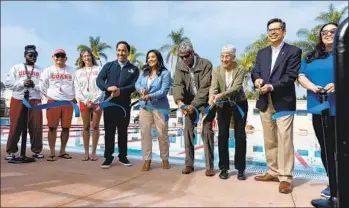  ?? ?? Mayor Todd Gloria (fourth from left) cuts a ceremonial ribbon with city staff members and the grandchild­ren of Bud Kearns, Carol Nicolson and John Kearns (third and fourth from right).