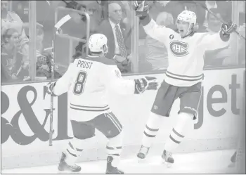  ?? THE CANADIAN PRESS/AP-LYNNE SLADKY ?? Montreal Canadiens left wing Jacob De La Rose (25) celebrates with right wing Brandon Prust (8) after scoring a goal during the second period of an NHL hockey against the Florida Panthers, Tuesday, March 17, 2015, in Sunrise, Fla. The Montreal...