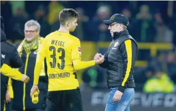  ?? — Reuters ?? Borussia Dortmund coach Peter Stoeger and Julian Weigl celebrate after the match.