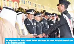  ??  ?? His Highness the Amir Sheikh Sabah Al-Ahmad Al-Jaber Al-Sabah awards one of the excelling cadets.