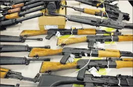  ?? Matt York ?? The Associated Press file A cache of seized weapons that were to be smuggled into Mexico is displayed in Phoenix. A report says that an estimated 253,000 firearms each year are bought in the United States to be sent to Mexico.