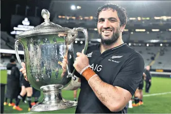  ??  ?? Return to form: All Blacks captain Sam Whitelock holds the Bledisloe Cup after victory over Australia in Auckland