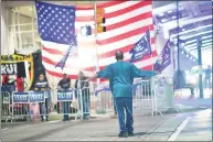  ?? Mark Makela / TNS ?? A man approaches supporters of President Donald Trump demonstrat­ing outside of where votes are counted in Philadelph­ia Nov. 9, six days after the general election.
