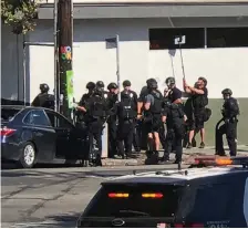  ?? Photo: Christian Dunlop via AP ?? Police use a mirror to see inside the Trader Joe’s store during the three-hour siege.