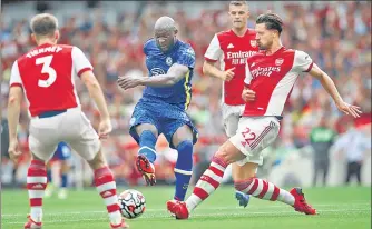  ?? REUTERS ?? Chelsea's Romelu Lukaku shoots past Arsenal's Kieran Tierney and Pablo Mari during their Premier League match on Sunday.