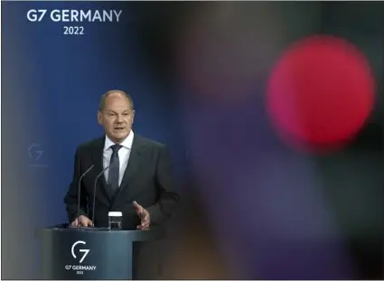  ?? MARKUS SCHREIBER — THE ASSOCIATED PRESS ?? German Chancellor Olaf Scholz speaks during a press conference in Berlin on Friday. The German government will take a roughly 30percent stake in energy supplier Uniper as part of a rescue package following surging prices for natural gas and reduced Russian deliveries.