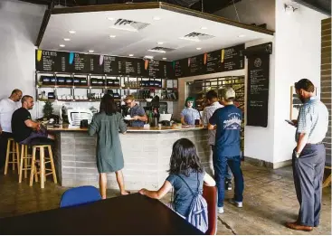  ?? Erin Hull ?? Patrons spend their morning at Morningsta­r, a new breakfast and coffee spot. Morningsta­r’s doughnuts, made with unbleached, unadultera­ted flour, are larger and weightier than traditiona­l raised-yeast doughnuts.