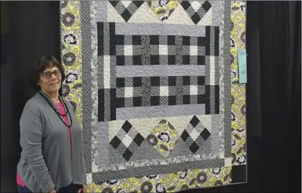  ?? PHOTO TOM BODUS ?? Carol Sassie, a member of the Desert Quilters of Imperial Valley, poses with the quilt she entered in this weekend’s show.