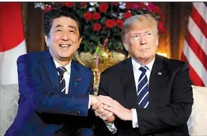  ?? AP/PABLO MARTINEZ MONSIVAIS ?? Japanese Prime Minister Shinzo Abe and President Donald Trump pose for photos Tuesday at Trump’s Mar-a-Lago club in Palm Beach, Fla., before holding talks on North Korea in private.