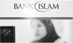  ?? – Reuters photo ?? Bank Islam expects to achieve a loan growth of seven per cent to eight per cent next year, slightly lower than this year’s target, amid the challengin­g business environmen­t.