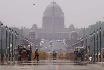  ?? Manish Swarup, The Associated Press ?? A constructi­on worker walks across a mirage created on a road following a heat wave in New Delhi on Monday.