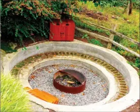  ?? The Associated Press ?? A fire ring ispictured in the backyard of a Langley, Wash., home is shown and is one of many health-related themed spaces becoming popular in landscape design. It's the kind of hardscapin­g that provides enjoyment as family lifestyles evolve.Wellness is...