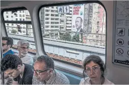  ?? SERGEY PONOMAREV THE NEW YORK TIMES FILE PHOTO ?? A commuter train passes an election poster for President Recep Tayyip Erdogan in Istanbul. Driven by fear of persecutio­n and economic mismanagem­ent, an exodus threatens to reorder the society and set Turkey back decades.
