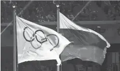  ?? ANDREJ ISAKOVIC, AFP/ GETTY IMAGES ?? The Olympic and Russian flags waved side- by- side during the 2014 Sochi Games, which have been tainted by Russia’s doping.