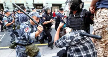  ??  ?? A serviceman of the Russian National Guard beats a protester during a rally against planned increases to the nationwide pension age in Moscow. — Reuters photo