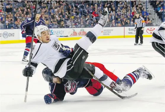  ?? — GETTY IMAGES FILES ?? David Savard, bottom, of the Columbus Blue Jackets drags Devin Setoguchi of the Kings down to the ice during action earlier this month in Columbus. Setoguchi is attempting to re-establish himself as a top player in the NHL.