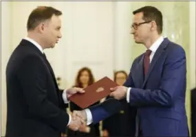  ?? ALIK KEPLICZ — THE ASSOCIATED PRESS ?? Polish President Andrzej Duda, left, formally designates Finance Minister Mateusz Morawiecki for the prime minister’s post, in Warsaw, Poland, on Friday.