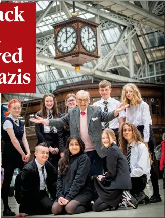  ?? Picture: Mark Owens/pa ?? Henry Wuga at Glasgow Central Station with pupils from Shawlands Academy