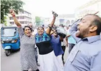  ?? Associated Press ?? Supporters of ousted prime minister Ranil Wickeremes­inghe celebrate outside the supreme court complex in Colombo on Thursday.