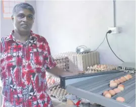  ?? Photo: RONAL DEO ?? Poultry farmer, Mr Ratish Chandra, shows the seven different egg grading sizes he is able to get from the egg grading machine from the Ministry of Agricultur­e.