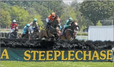  ?? PHOTO BY NICK TOPPING ?? The horses jump the first hurdle during the Mrs. Ogden Phipps Stakes on Thursday. Swoop, ridden by Bernard Dalton, won in the race.