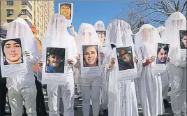  ?? AFP ?? ■ Demonstrat­ors in New York carry the photos of victims of gun violence during a March for Our Lives rally in New York on Saturday.