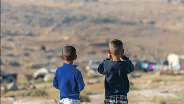  ?? PICTURE: CLAIRE THOMAS ?? VULNERABLE YOUNG LIVES: Muhammad Nawajah and his brother look out over their temporary settlement in the South Hebron Hills. Their father, Nasser Nawajah, a comunity leader, is under administra­tive detention by Israel for his resistance to repeated...
