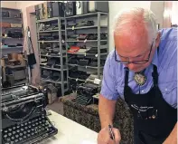  ??  ?? John Lewis, a typewriter repairman, works at his shop in Albuquerqu­e in front of his collection of vintage typewriter­s. The typewriter is making a comeback with a new generation of fans gravitatin­g to machines that once gathered dust.