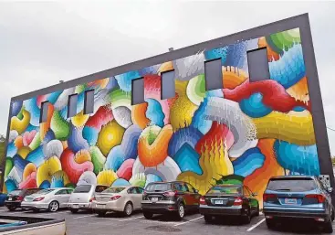  ?? Robin Soslow photos ?? This huge mural, named Space Rainbows, was painted by California artist Ricky Watts on the Sage Building in St. Petersburg’s Central Arts District.